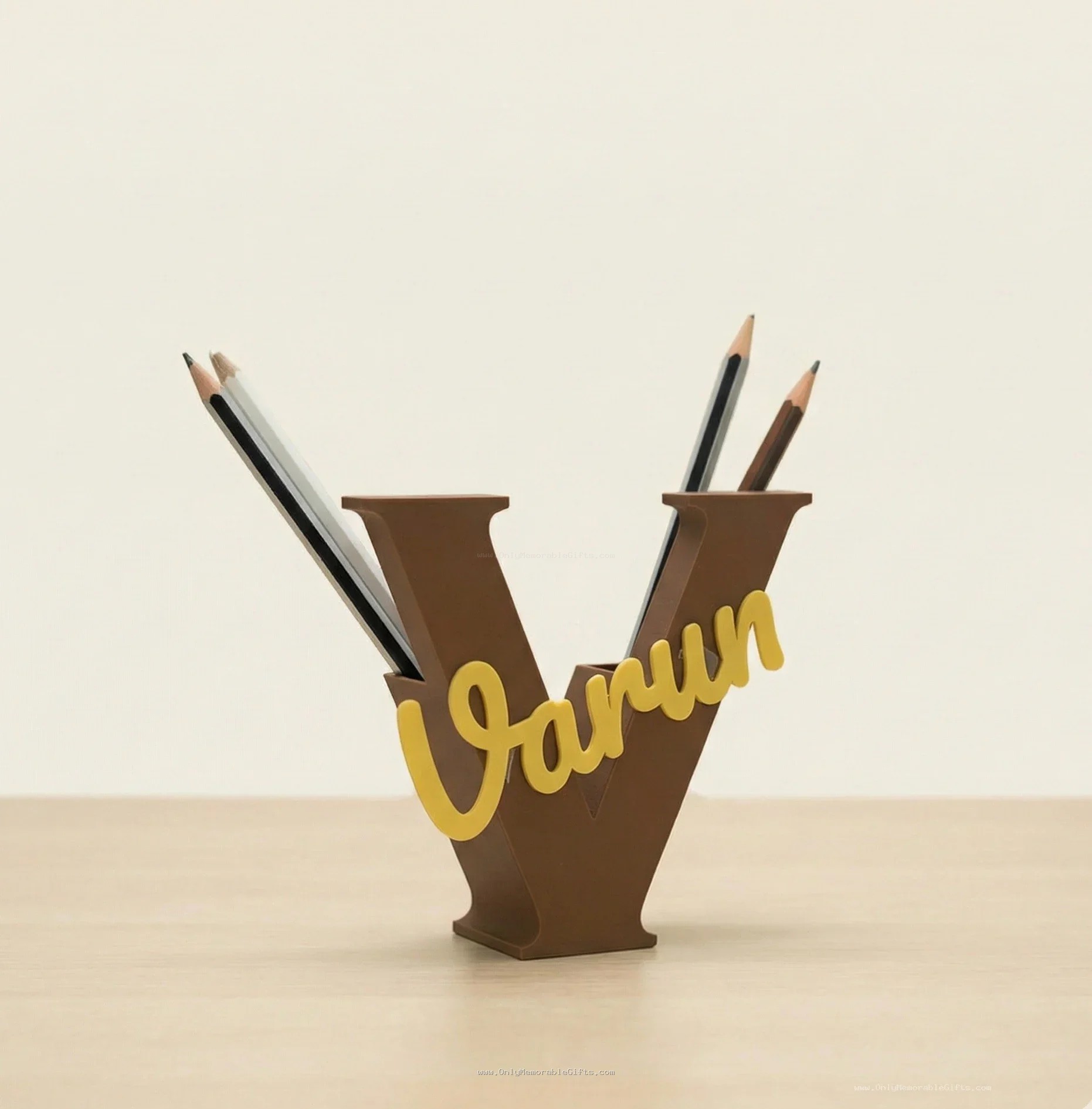 Brown letter V pencil holder with custom name Varun in golden