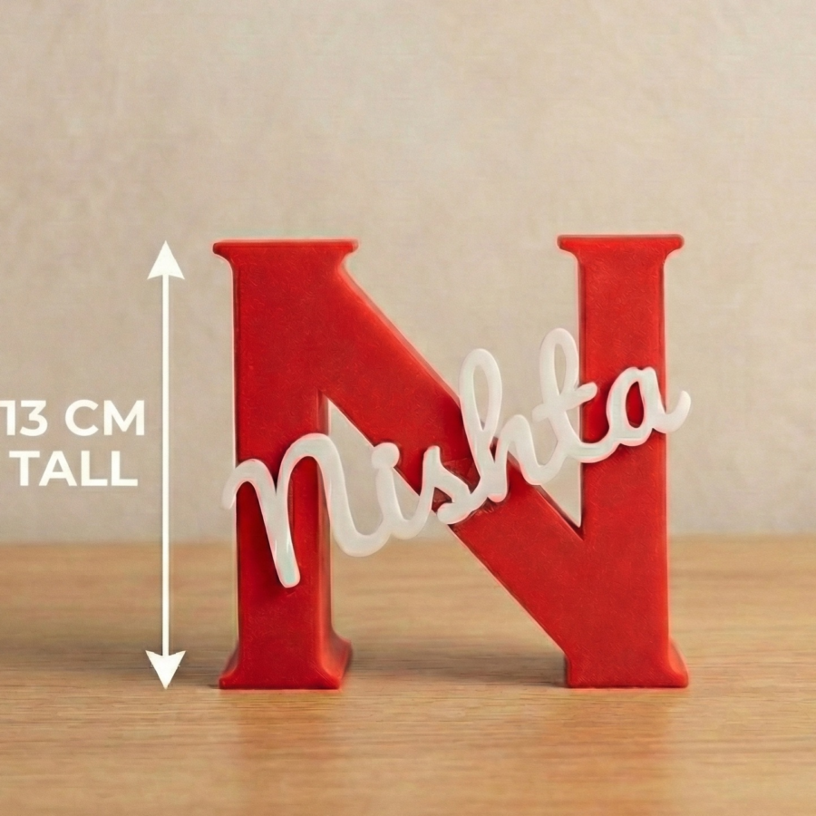 Red 3D printed letter N pen stand with custom name Nishta in white cursive