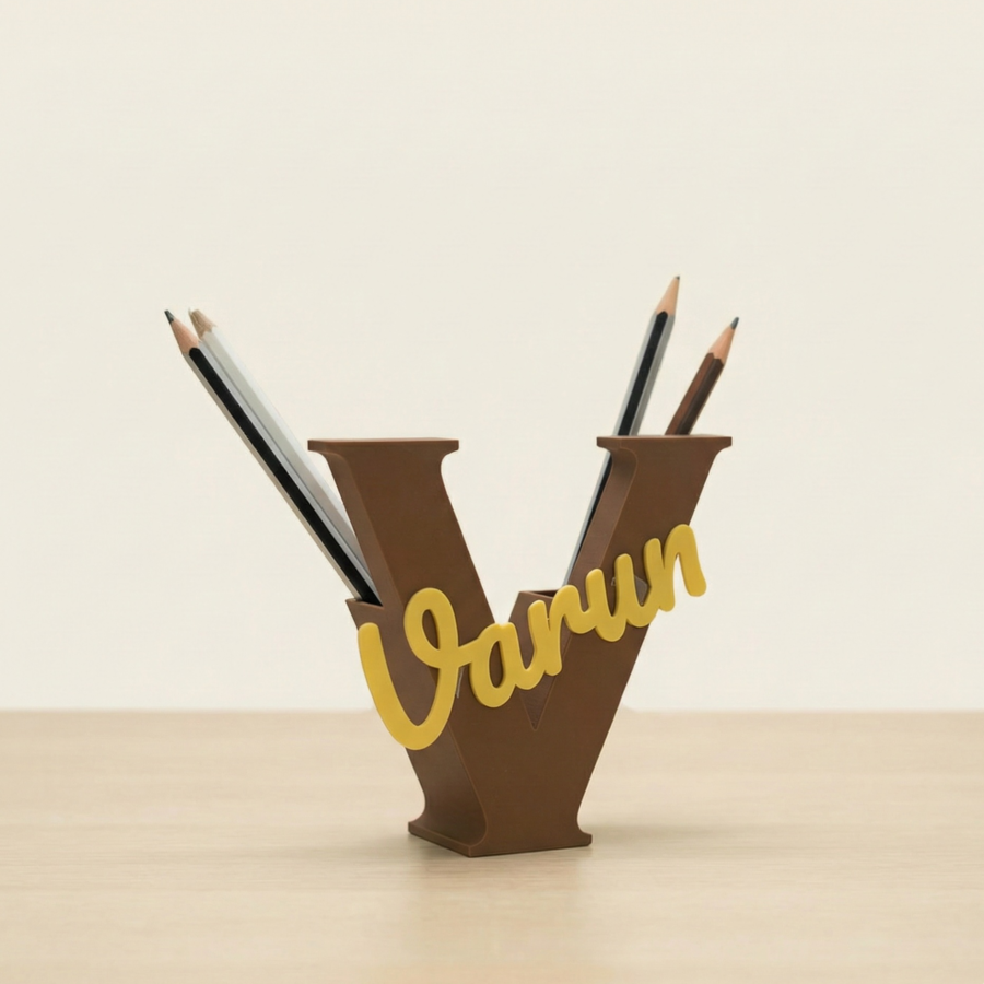 Brown letter V pencil holder with custom name Varun in golden