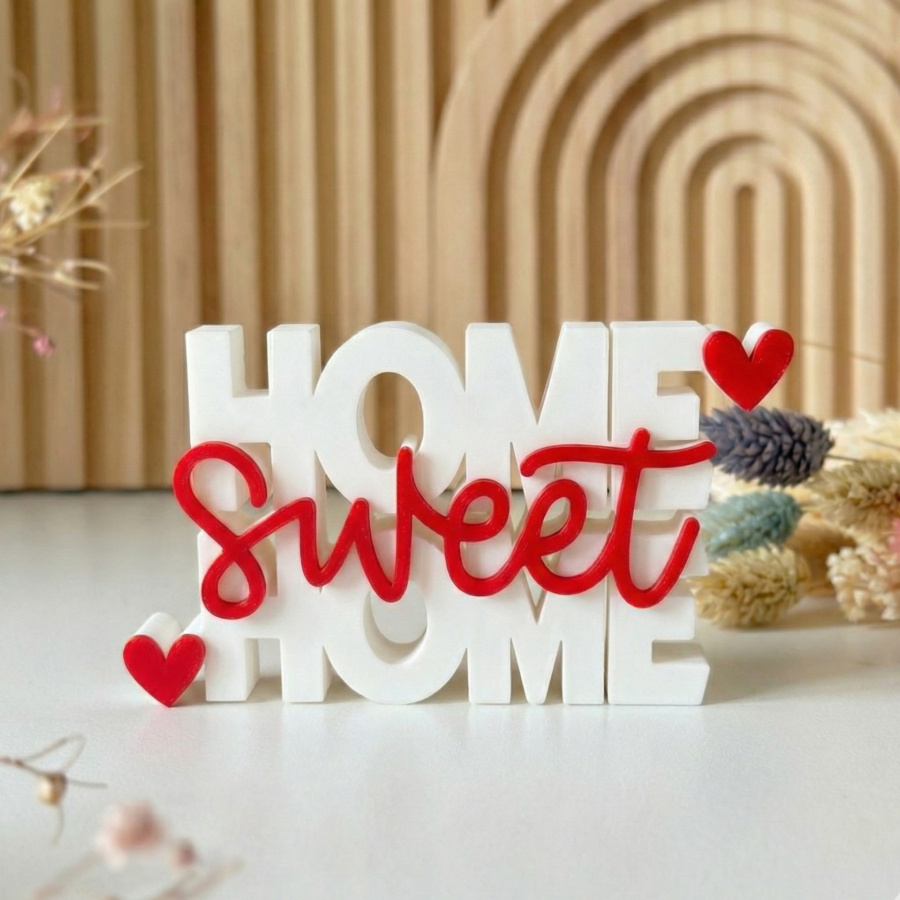White 3D printed Home Sweet Home sign with red cursive text and red hearts.