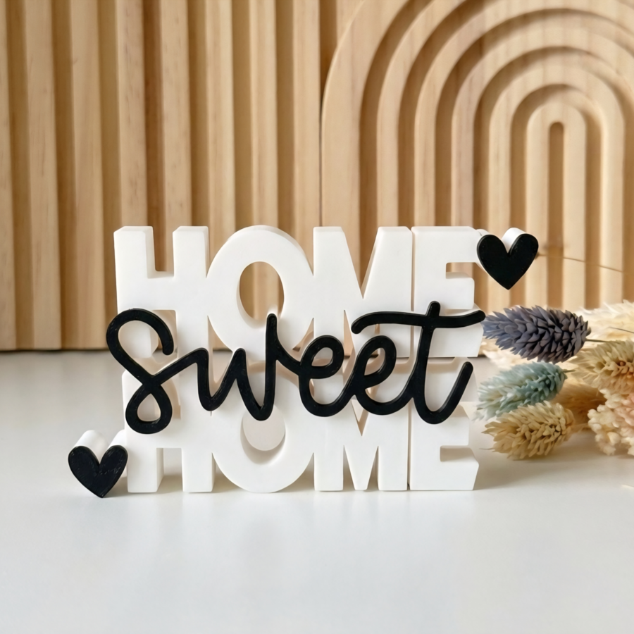 Modern stacked Home Sweet Home shelf decoration with black script and hearts.